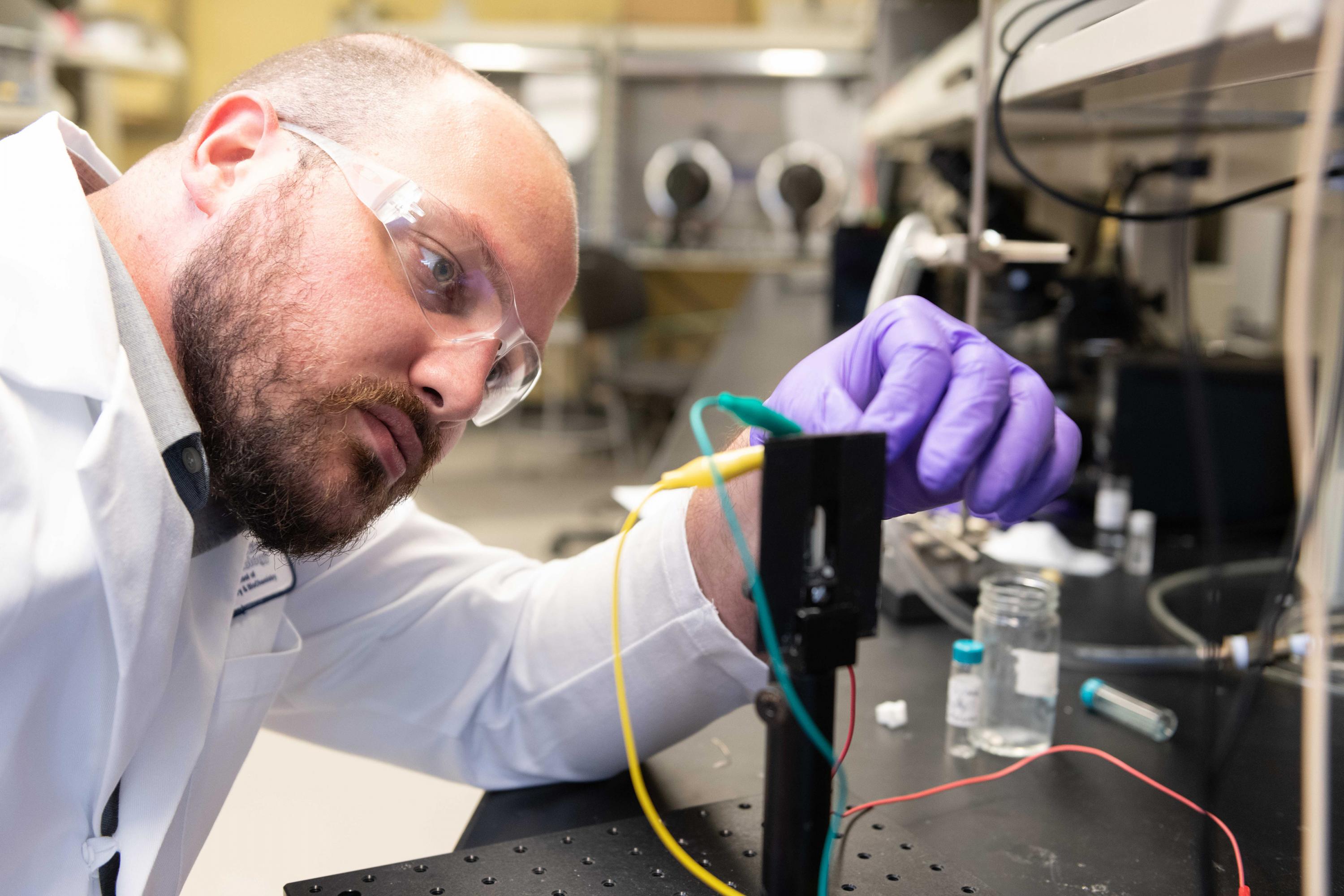 Graduate Research Assistant Dylan Christiansen studies the electrochromic properties of new materials in a transparent electrochemical cell that allows examination of color change upon application of an oxidizing voltage. (Photo: Allison Carter, Georgia Tech) Graduate Research Assistant Dylan Christiansen studies the electrochromic properties of new materials in a transparent electrochemical cell that allows examination of color change upon application of an oxidizing voltage. (Photo: Allison Carter, Georgia Tech)