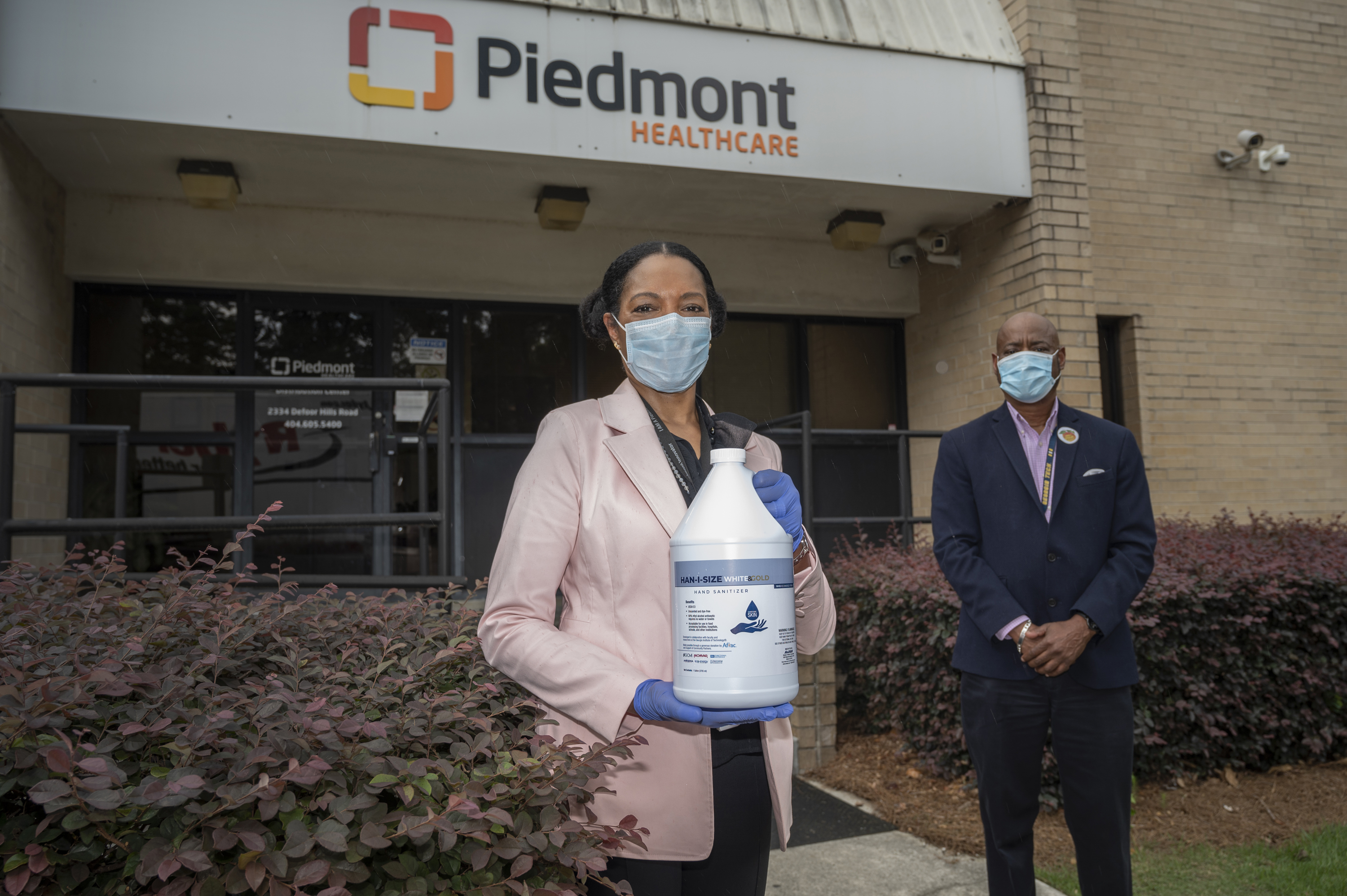Dr. Jayne Morgan welcomes the first delivery of the newly designed, ethanol-based hand sanitizer to Piedmont Healthcare of Atlanta. Behind her, George White of Georgia Tech, a team member in the hand sanitizer initiative. Georgia Tech / Christopher Moore Dr. Jayne Morgan welcomes the first delivery of the newly designed, ethanol-based hand sanitizer to Piedmont Healthcare of Atlanta. Behind her, George White of Georgia Tech, a team member in the hand sanitizer initiative. Georgia Tech / Christopher Moore