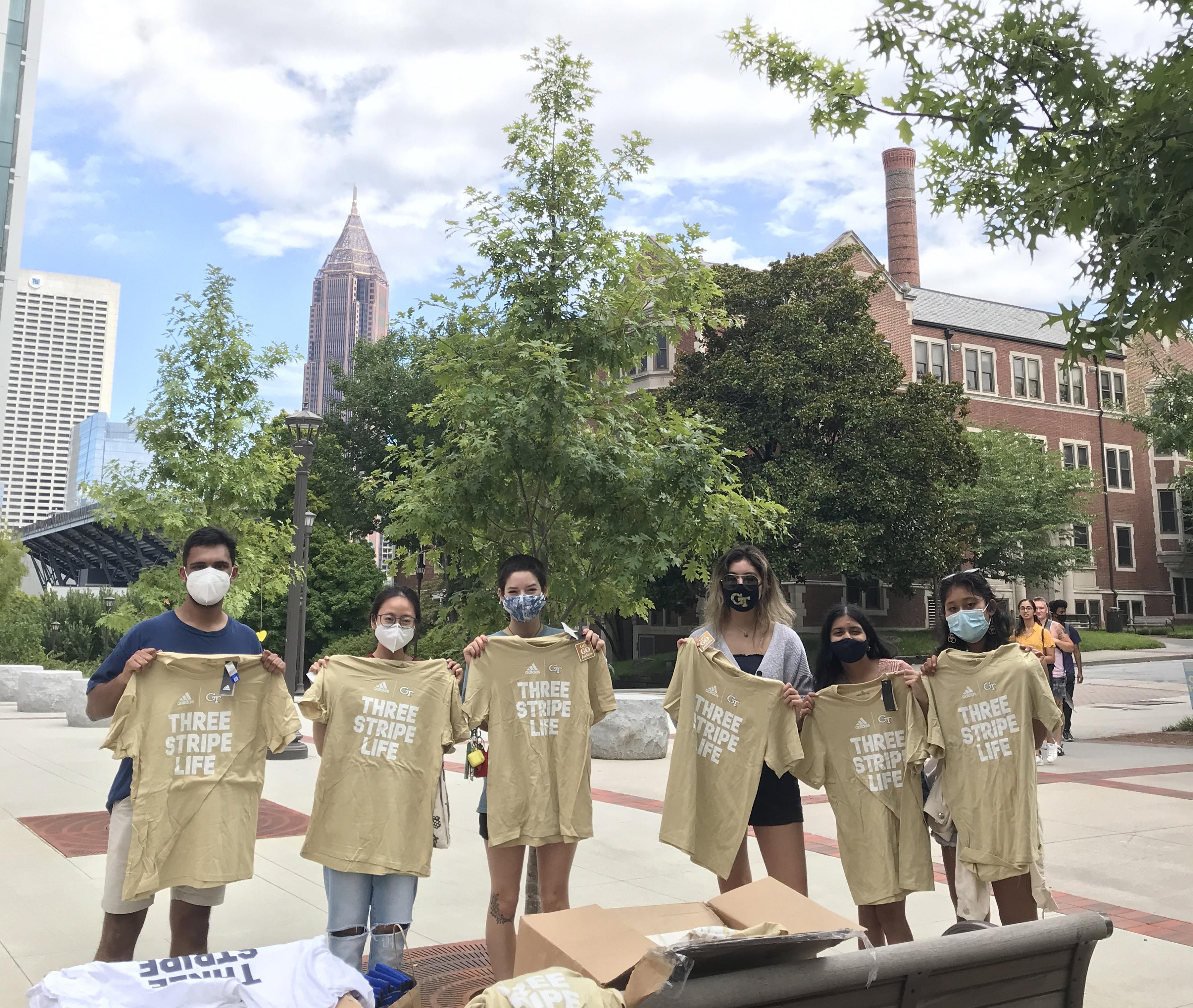 Mihir Kandarpa, vice president of Well-being for Undergrduate SGA (left) shares GT Athletics t-shirts and local restaurant discount cards with those participating in weekly asymptomatic surveillance testing at Georgia Tech. Mihir Kandarpa, vice president of Well-being for Undergrduate SGA (left) shares GT Athletics t-shirts and local restaurant discount cards with those participating in weekly asymptomatic surveillance testing at Georgia Tech.